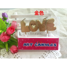 "Love" letters shaped stick candles for valentine cake