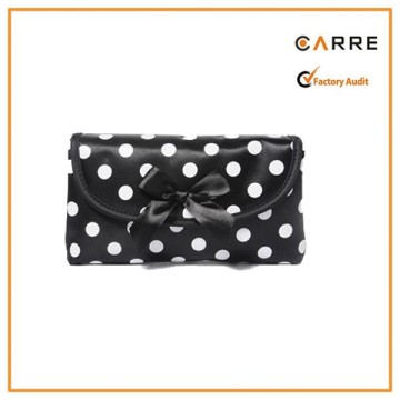 magnetic button closure black and white polka dot satin cosmetic clutch bag with bow