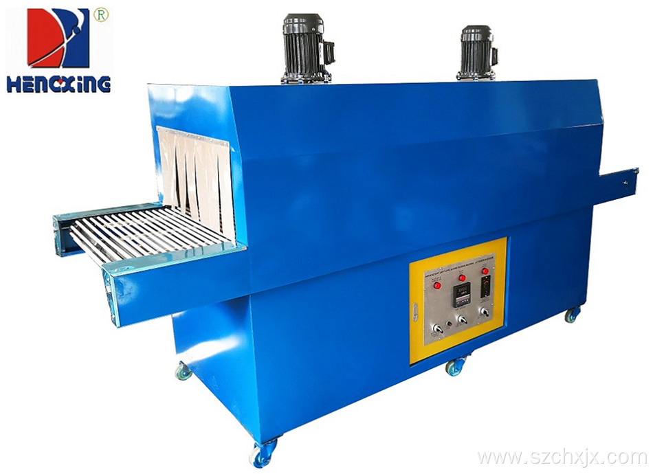 Plastic film shrink wrapping packing machine