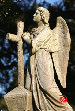 Weeping angel tombstone praying looking up