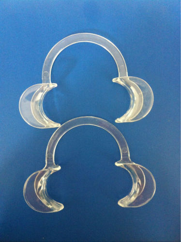 Open mouth gag, tooth whitening cheek retractor with flexible material