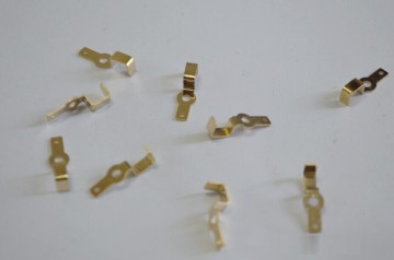 Metal stamping with gold-plated bent shrapnel