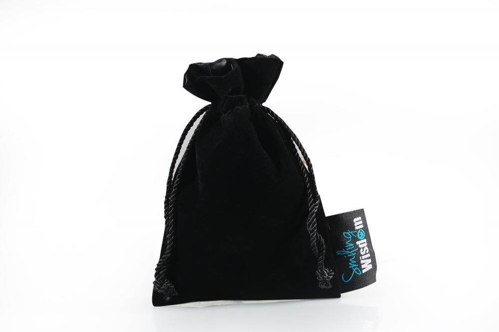 black velvet gifts bag with label 