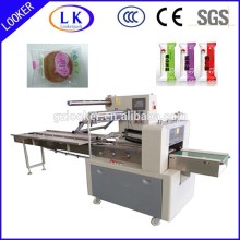 Horizontal flow packing machine for regular solid object pillow bag packing