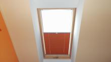 Orange pleated skylight blinds