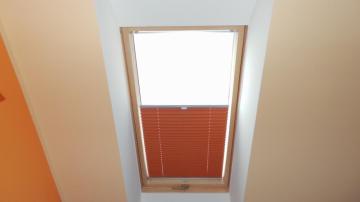 Orange pleated skylight blinds