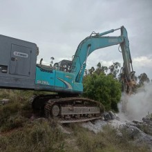 Versatile Excavator modified into down-the-hole drill