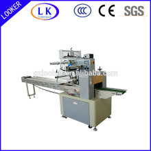 Horizontal flow pack wrapping machine