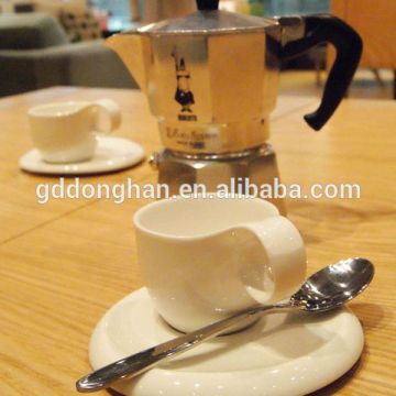 white ceramic coffee cups and saucers