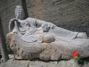 Stone lying kuan yin statue