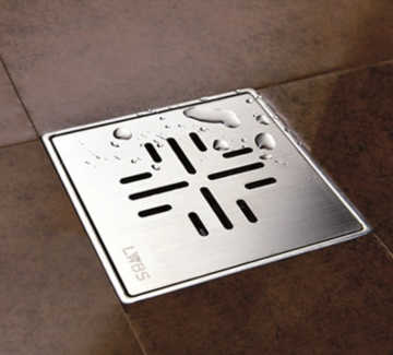 Square floor drain in the hotel bathroom