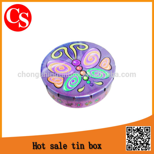 small round click clack tin box