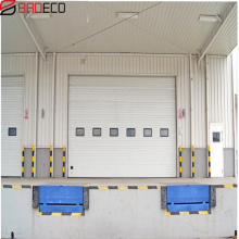 Sectional industrial door with dock shelter and dock lever