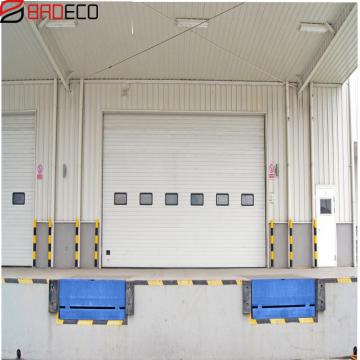 Sectional industrial door with dock shelter and dock lever