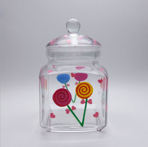 Jarra de dulces de vidrio con tapa y caja de color