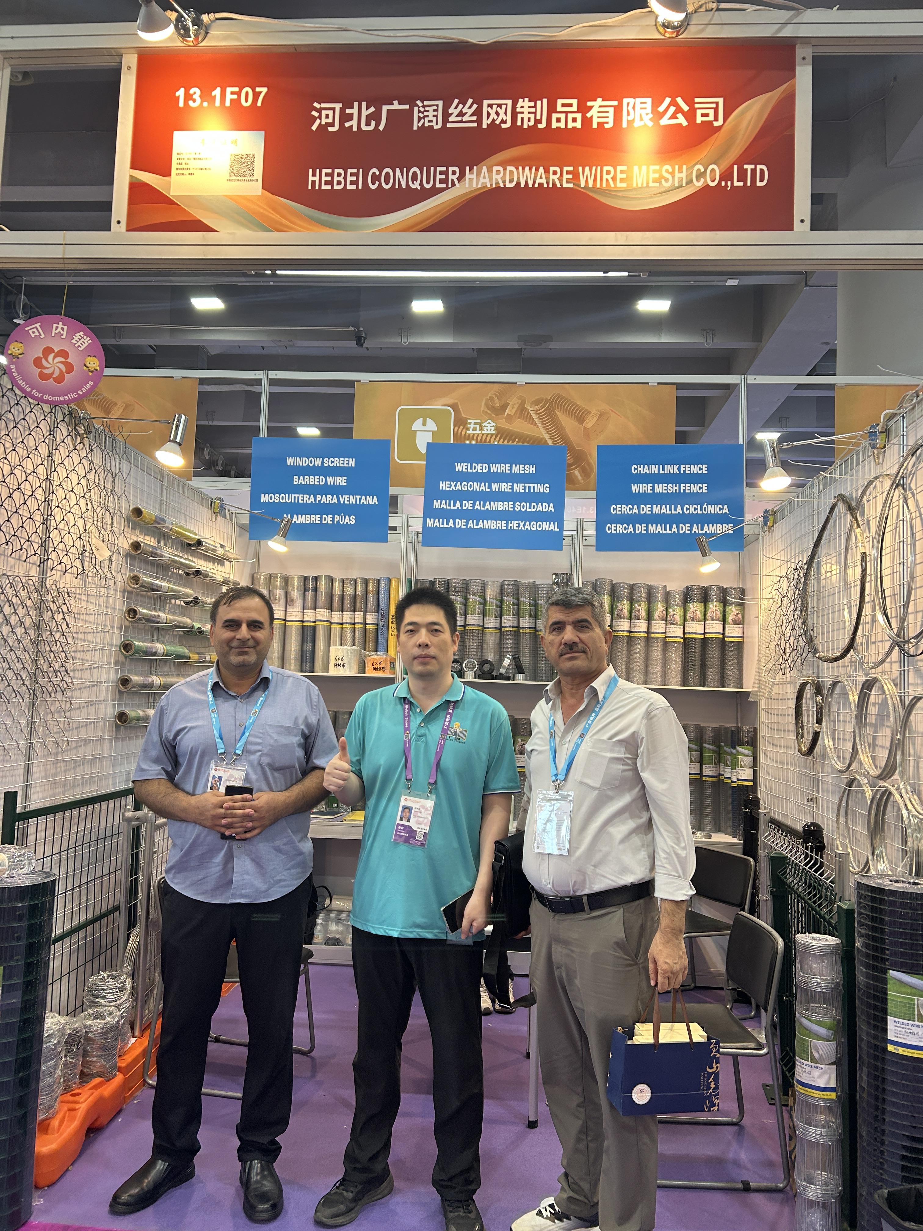 Display aus geschweißtem Drahtgeflecht | 140. Kantonsmesse Two buyers with ANJIA staff in front of the welded wire mesh shelves at Booth 13.1F07
