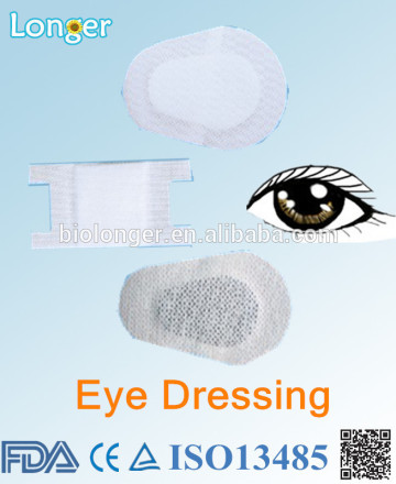 Medical wound dressing for eye with net-spun laced nonwoven baseband