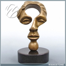 Black marble base abstract face bronze sculpture