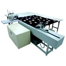 Mattress bingding working station with pulling system