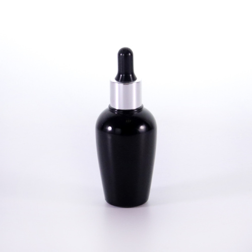 Schwarze Glasflasche mit silbernen Tropfenkappe