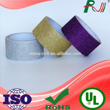 Patterned adhesive covering glitter tape