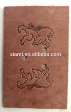 factory offer good price debossed cool lion top layer leather labelin jeans
