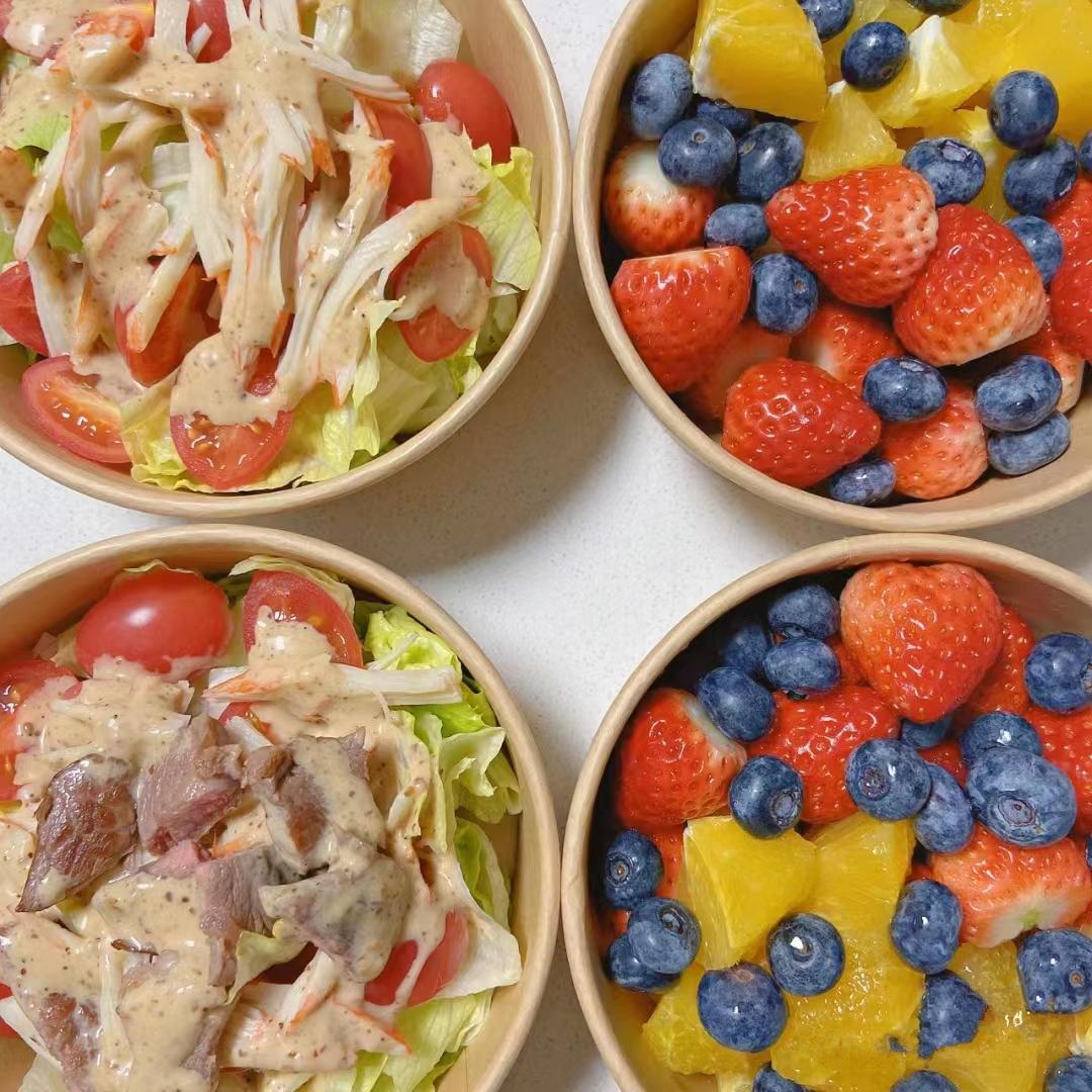 Cut fruit in brown paper bowls