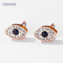 Boucles d'oreilles avec oeil diabolique en or rose et strass