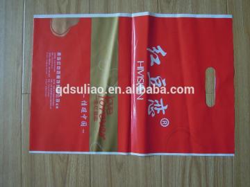 red plastic die cut shopping bag with logo