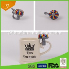 cream colour beer mug with colour bell