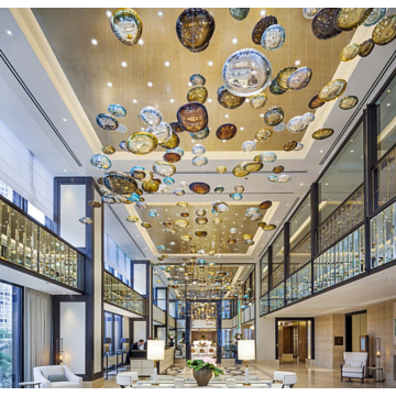 Amber chandelier in the center of hotel lobby