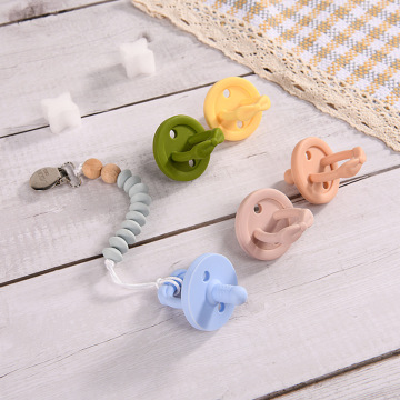Solid silicone baby pacifier with chain clip