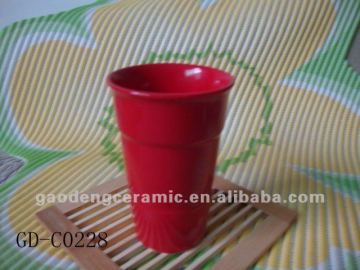 red ceramic tea mug without handle