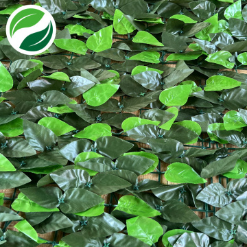 Artificial leafy green plants mixed with peach leaves