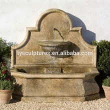 Large outdoor courtyard decorative stone antique wall fountain yellow marble ledge fountain