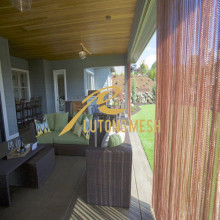 Decorative hanging metal coil drapery room divider