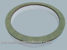 Vitrified diamond bruting wheel for grinding magnetized materials