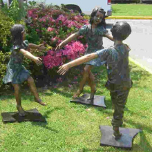 large outdoor sculpture bronze children going round in circles sculpture