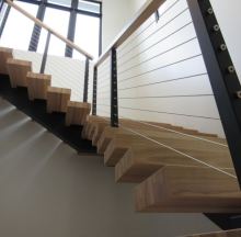 staircase wooden treads with brushed steel rope guardrail