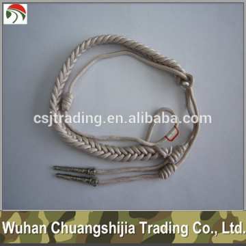 white military uniform aiguillettes with insignia