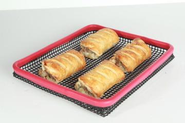 Oven crisper tray made from PTFE mesh with red silicone trim