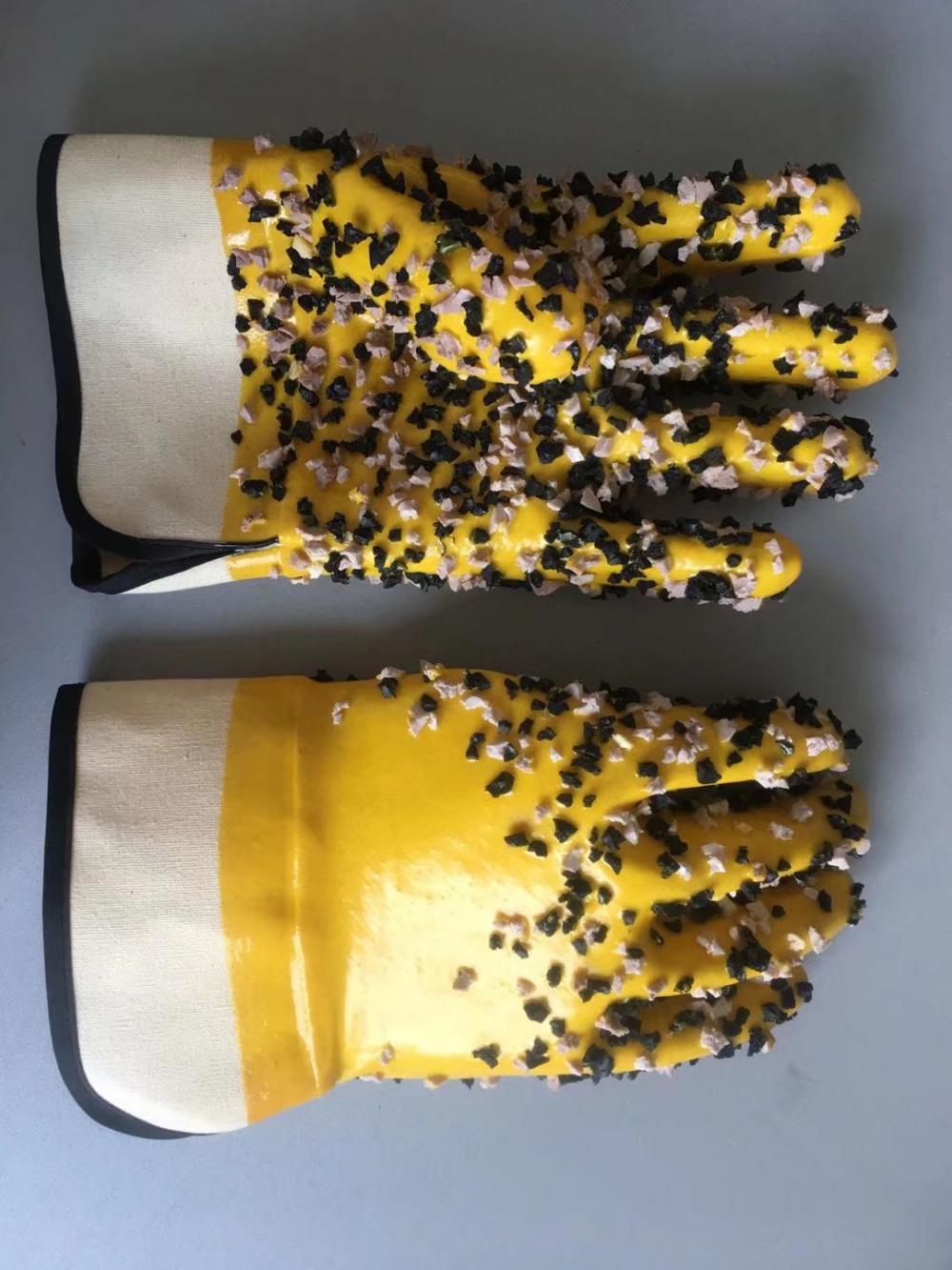 Yellow pvc gloves with chips on the palm