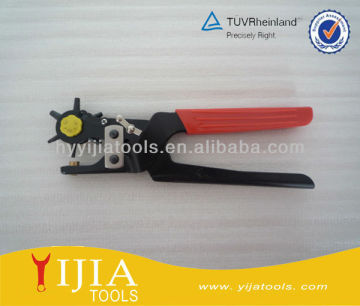 Hand holding adjustable belt hole puncher