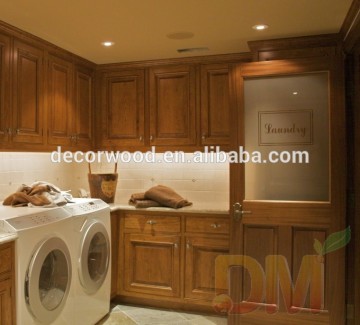 honey color Maple wood laundry room custom cabinetry