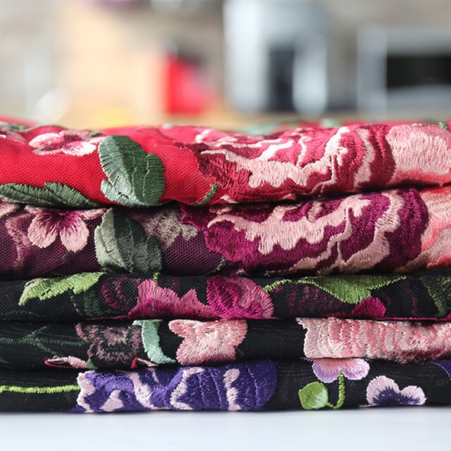 Colorido bordado de inflorescencia en tela de malla de nylon