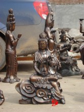sitting bronze kuan yin statue with wicker