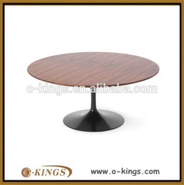 Big wooden dining table with round metal plate