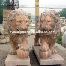 The lion statues standing on the ball