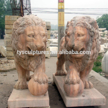 The lion statues standing on the ball