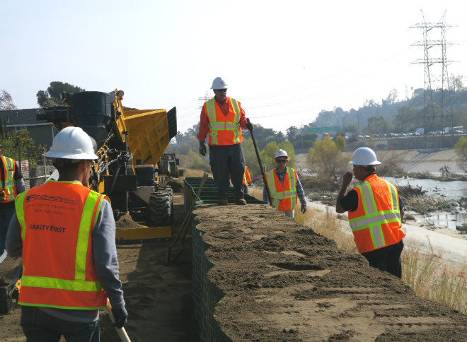 worker-on-top-of-hesco-barrier-in-atwater